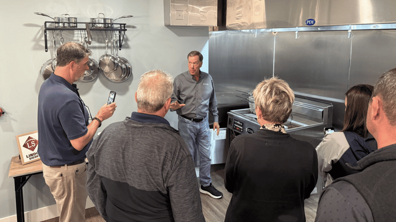 Five customers stand in front of Lindox Siegel team member doing training on Royal filtration