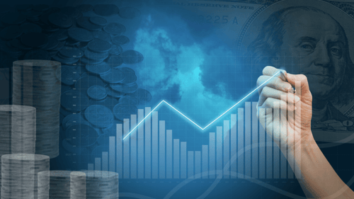 Image of profits chart going up with hand directing the arrow. Image of Ben Franklin in background. 