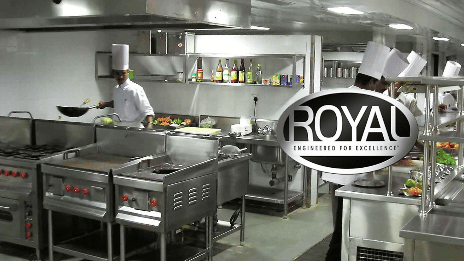 Commercial kitchen with chefs working. Royal logo on left side of image.