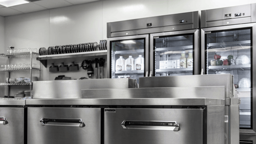 Kelvinator commercial glass door refrigerators and chef base units in a professional kitchen setting