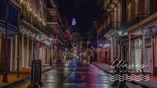 Dark street scene looking down street in New Orleans with logo 'Wave of Goodness' in lower right corner